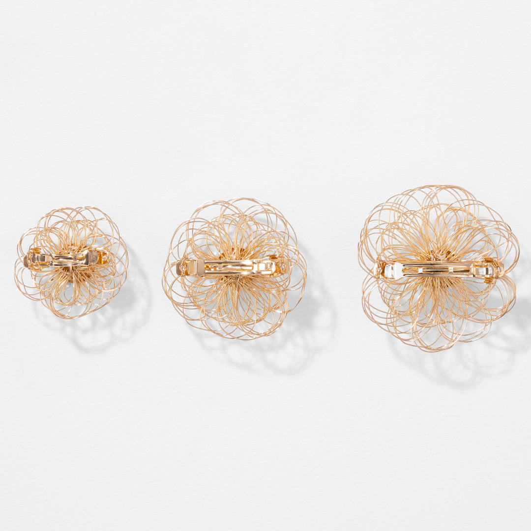 Presilha de cabelo em forma de flor feita com arame dourado