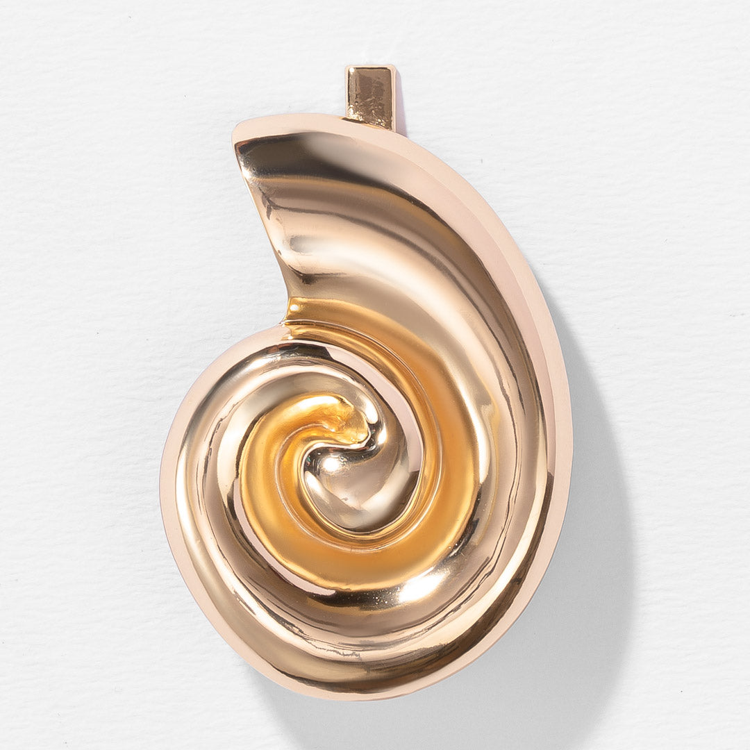 Gold spiral pendant on a light gray background