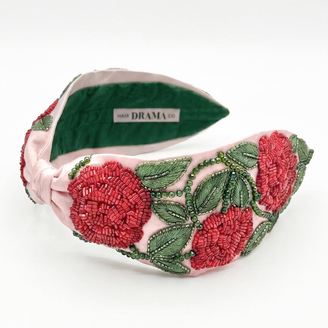 Hand-beaded rose headband with detailed embroidery in rich pink and green on satin base