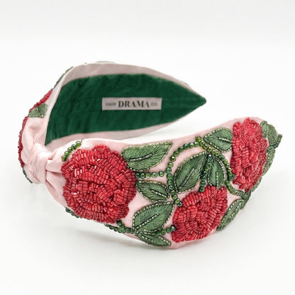 Hand-beaded rose headband with detailed embroidery in rich pink and green on satin base