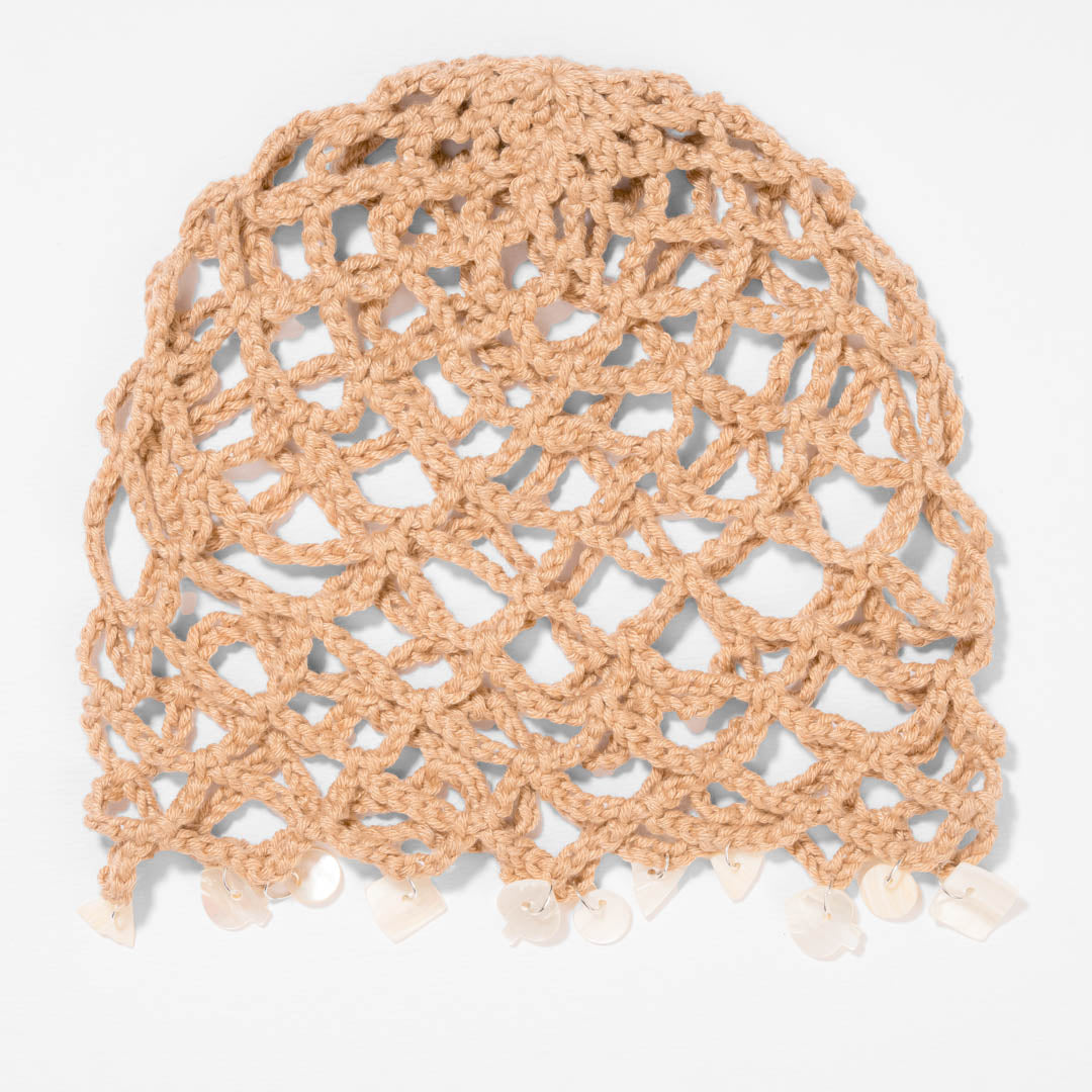Neutral beige crochet beanie with shell accents for effortless coastal-inspired looks.