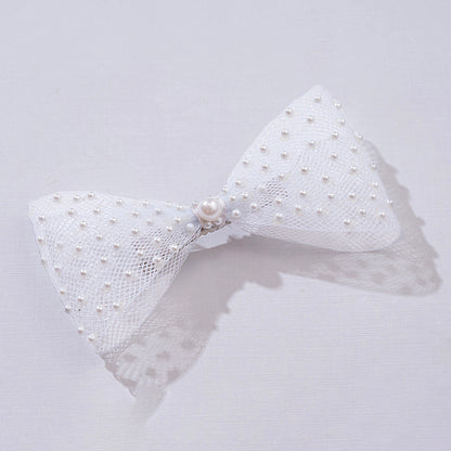 White bow hair accessory with pearls on a light gray background, featuring the brand 'Hair Drama Co.'